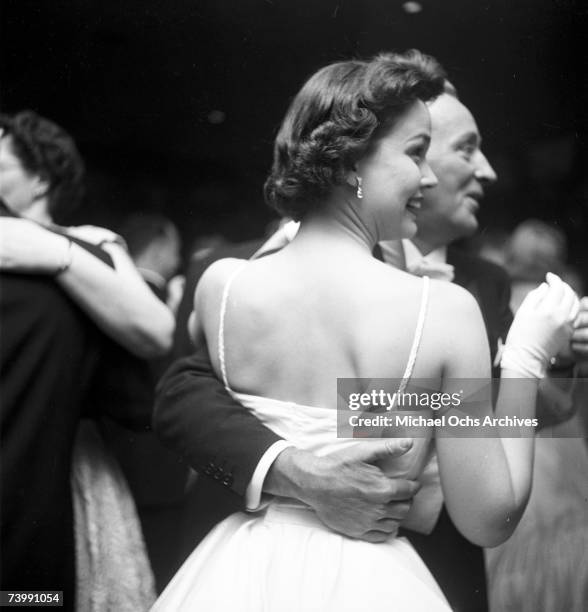 Entertainer Bing Crosby and his future wife Kathryn Grant attend the Academy Awards ceremony on March 30, 1955 in Los Angeles, California.