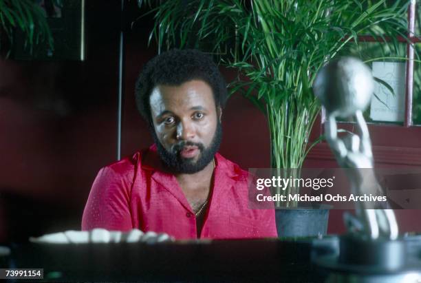 Singer and composer Andrae Crouch plays the piano at his home in October 1982.