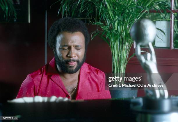 Singer and composer Andrae Crouch plays the piano at his home in October 1982.