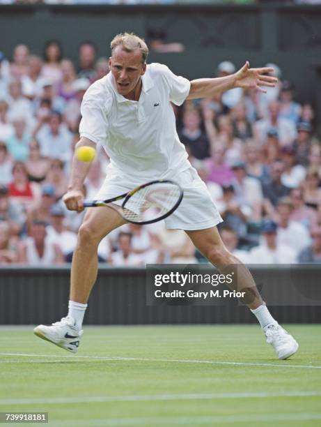 Daniel Vacek of the Czech Republic makes a backhand return against Patrick Rafter in their Men's Singles first round match at the Wimbledon Lawn...