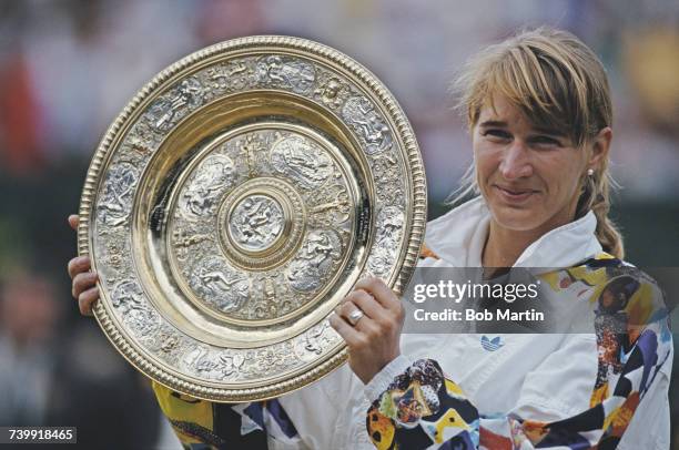 Steffi Graf of Germany holds aloft the Venus Rosewater Dish after defeating Jana Novotna in their Women's Singles Final match at the Wimbledon Lawn...