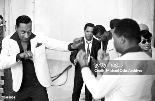 Abdul "Duke" Fakir and Ronaldo "Obie" Benson of the R&B vocal group "The Four Tops" pretend to box as the head of Motown Berry Gordy chats with lead...