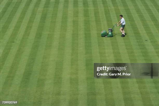 Groundsman cuts the grass on the Centre Court in preperation for the Wimbledon Lawn Tennis Championships on 19 June 1994 at the All England Lawn...