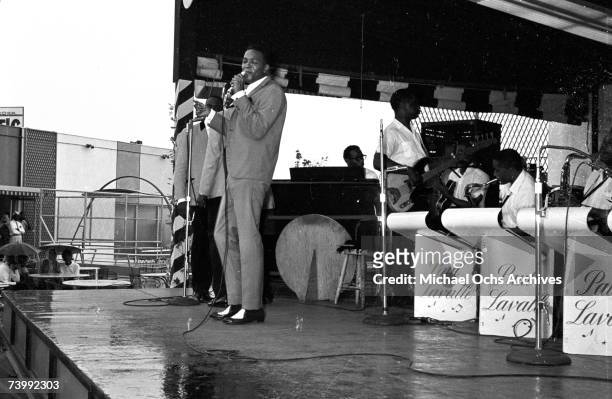Singer Marvin Gaye performs onstage with a full band and doo-wop vocal group "The Spinners", which included Bobbie Smith, Edgar "Chico" Edwards,...