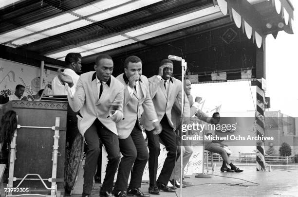 Vocal group "The Spinners", which included Bobbie Smith, Edgar "Chico" Edwards, Billy Henderson, Henry Fambrough, Pervis Jackson, perform in the rain...