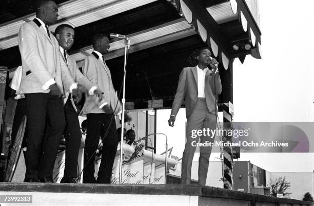 Singer Marvin Gaye performs onstage with a full band and doo-wop vocal group "The Spinners", which included Bobbie Smith, Edgar "Chico" Edwards,...