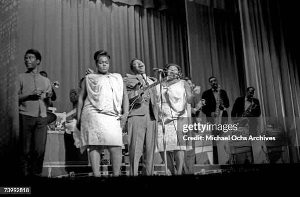 Blues musician B.B. King performs onstage with his Gibson hollowbody electric guitar nicknamed "Lucille" and "The Soul Sisters" in 1963 at the Apollo...