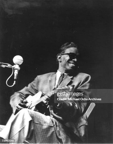 Bluesman Lightnin' Hopkins performs at the Newport Folk Festival on July 24, 1965 in Newport, Rhode Island.