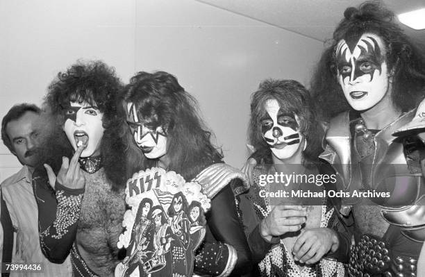 Paul Stanley, Ace Frehley, Peter Criss and Gene Simmons of the rock and roll band Kiss receive presents from their fans backstage in 1976 in Los...