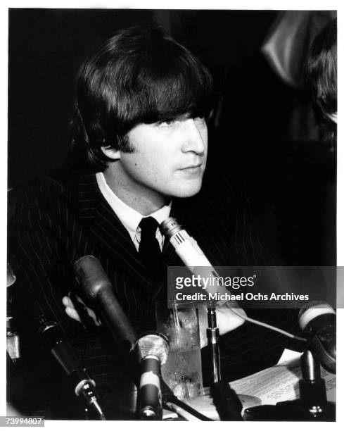 Singer and guitarist John Lennon of the rock and roll band "The Beatles" ponders a question during a press conference at the Cinnamon Cinder youth...