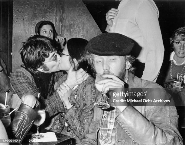 Singer-guitarist John Lennon, formerly of The Beatles, attends a Smothers Brothers comedy performance with girlfriend May Pang and fellow...