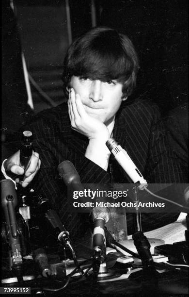 Singer and guitarist John Lennon of the rock and roll band "The Beatles" ponders a question during a press conference at the Cinnamon Cinder youth...