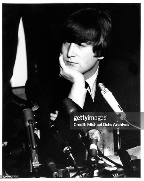 Singer and guitarist John Lennon of the rock and roll band "The Beatles" ponders a question during a press conference at the Cinnamon Cinder youth...