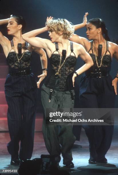 Pop singer Madonna performs onstage in spandex and a bustier with back up dancers in September 1989 in Los Angeles, California.