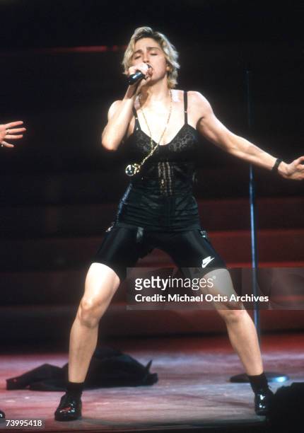 Pop singer Madonna performs onstage in spandex and a bustier with back up dancers in September 1989 in Los Angeles, California.