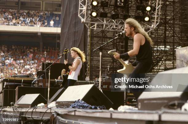 Bassist Jason Newsted and Singer and guitarist James Hetfield of the heavy metal quartet "Metallica" perform onstage at the "Monsters of Rock"...