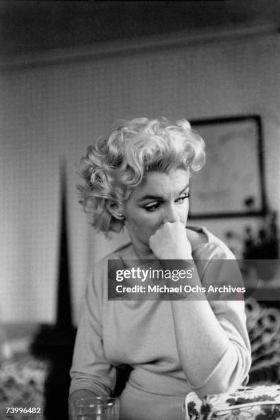 Actress Marilyn Monroe relaxes on a couch in her hotel room at the Ambassador Hotel on March 24, 1955 in New York City, New York.
