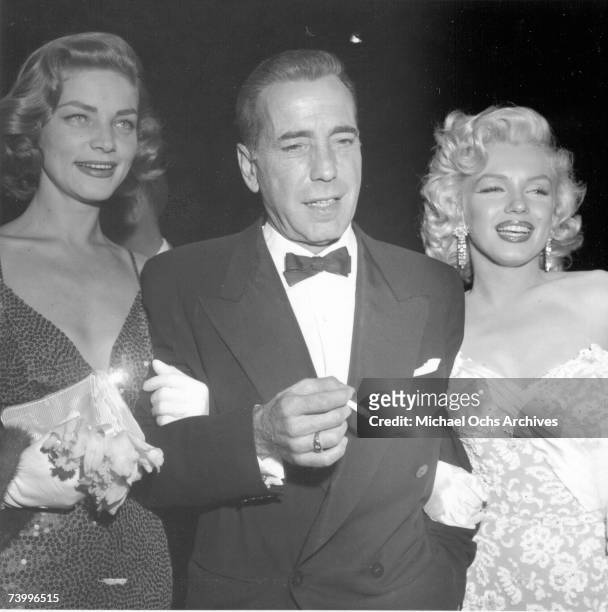 Actors Marilyn Monroe and Humphrey Bogart and Lauren Bacall attend the premiere of her movie "How To Marry A Millionaire" on November 4, 1953 in Los...