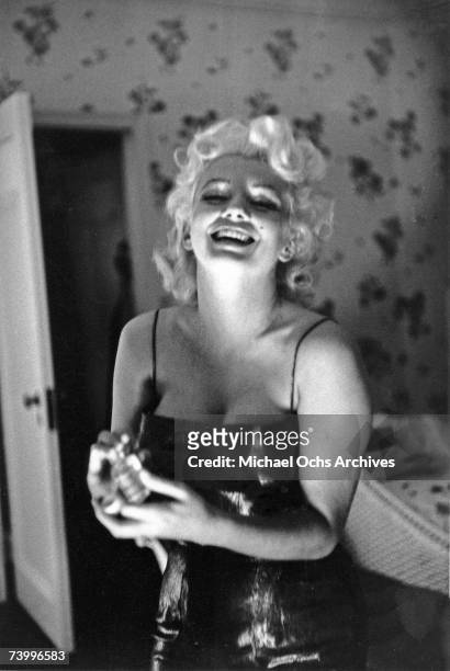 Actress Marilyn Monroe gets ready to go see the play "Cat On A Hot Tin Roof" playfully applying her make up and Chanel No. 5 Perfume on March 24,...