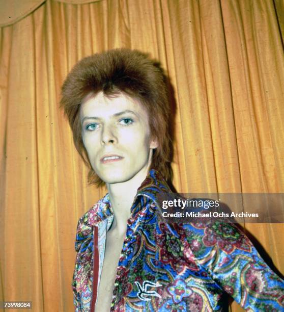 Rock and roll musician David Bowie poses for a portrait dressed as 'Ziggy Stardust' in a hotel room in 1973 in New York City, New York.