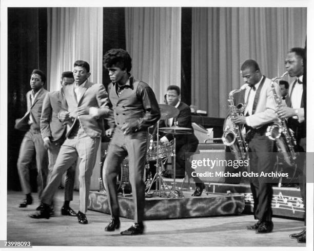 Soul singer James Brown performs onstage with Johnny Terry, Bobby Byrd and Bobby Bennett of the Famous Flames at the Apollo Theatre in New York, New...