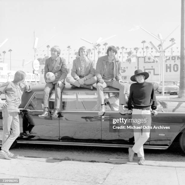 Superstar group "Buffalo Springfield" pose for a portrait sitting on a car in 1966 in Los Angeles, California. Bruce Palmer, Dewey Martin, Stephen...