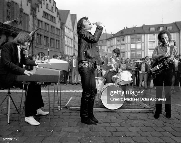 Ray Manzarek, Jim Morrison, John Densmore and Robbie Krieger perform on the street on September 14, 1968 in Frankfurt Germany,