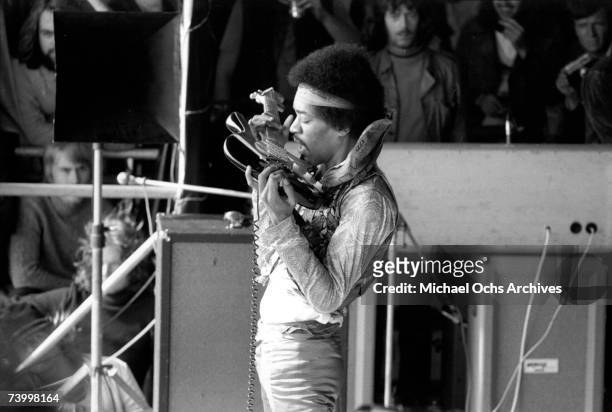 Rock guitarist Jimi Hendrix plays his Fender Stratocaster electric guitar with his teeth at his last concert on September 6, 1970 in Isle of Fehmarn,...