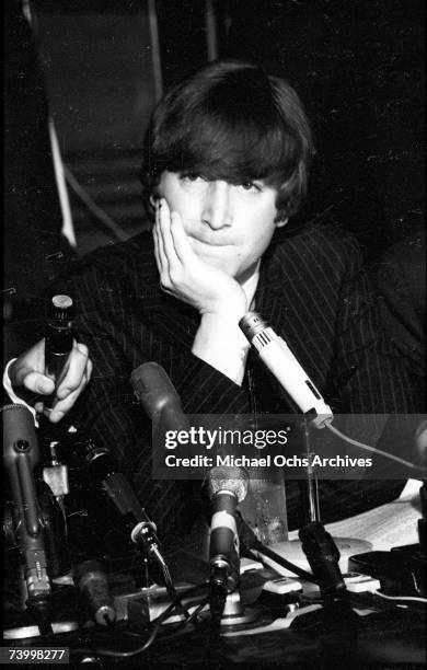 Singer and guitarist John Lennon of the rock and roll band "The Beatles" ponders a question during a press conference at the Cinnamon Cinder youth...