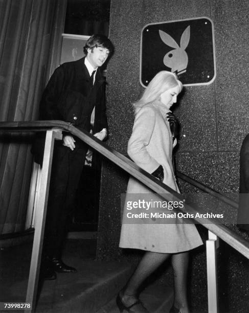 John Lennon of the rock and roll band "The Beatles" and his wife Cynthia Lennon visit The Playboy Club on February 9, 1964 in New York City, New York...