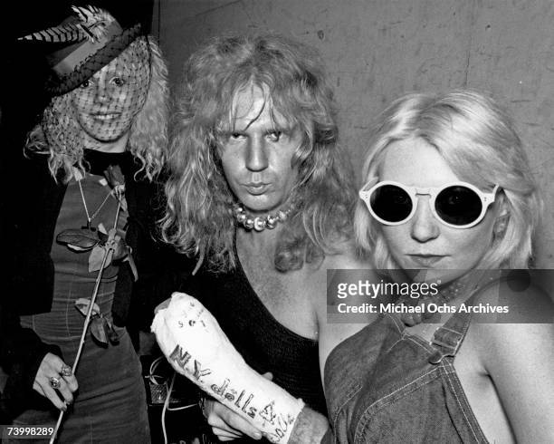 Bassist Arthur Kane of the glam rock band New York Dolls poses for a portrait with young groupies including Sable Starr in circa 1973 in Los Angeles,...