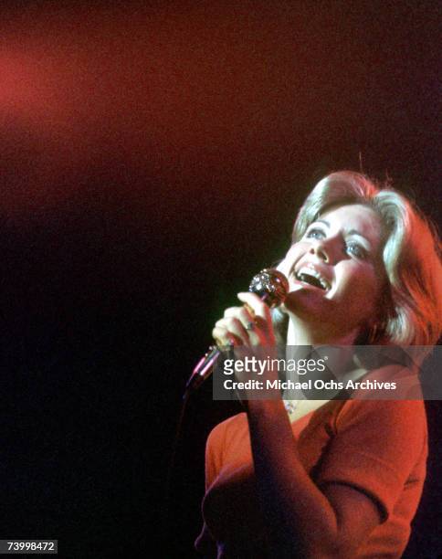 Singer Olivia Newton-John performs in 1975 in Detroit, Michigan