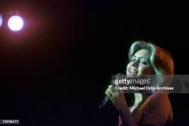 Singer Olivia Newton-John performs in 1975 in Detroit, Michigan