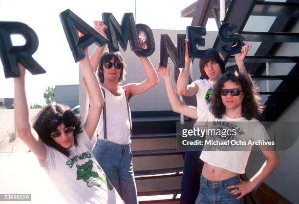 Joey Ramone, Dee Dee Ramone, Johnny Ramone and Tommy Ramone of the rock and roll band "The Ramones" pose for a portrait holding letters that spell...