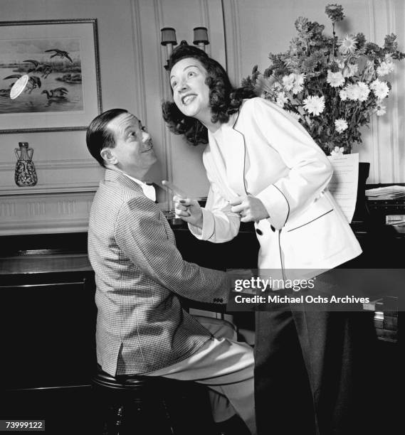 Songwriter Cole Porter and singer and actress Ethel Merman in his apartment in New York City circa 1939.