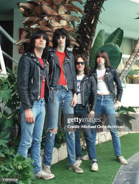 Dee Dee Ramone, Joey Ramone, Tommy Ramone and Johnny Ramone of the rock and roll band "The Ramones" pose for a portrait holding letters that spell...