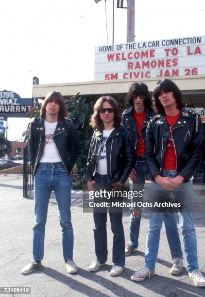 Johnny Ramone, Tommy Ramone, Joey Ramone and Dee Dee Ramone of the rock and roll band "The Ramones" pose for a portrait holding letters that spell...