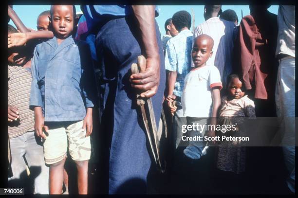 Man holds two machetes May 5, 1994 in Rukara, Rwanda. Hundreds of Tutsis were killed at the Rukara Catholic mission April, 1994 in one of the worst...