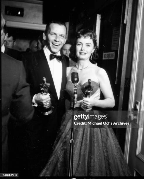 Actors Frank Sinatra and Donna Reed pose for a portrait after winning best supporting actor and best supporting actress Oscars on for their roles in...