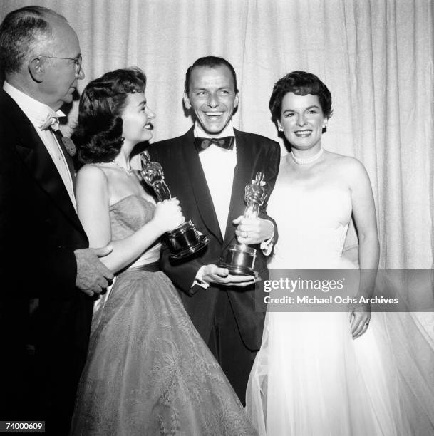 Movie stars Donna Reed and Frank Sinatra hold their Oscars which they won for Best Supporting Actress and Best Supporting Actor respectively in the...