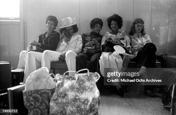 Singer Sly Stone of the psychedelic soul group "Sly & The Family Stone" awaits transportation with his actual family including his parents on August...