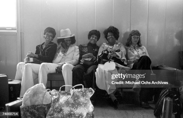 Singer Sly Stone of the psychedelic soul group "Sly & The Family Stone" awaits transportation with his actual family including his parents on August...