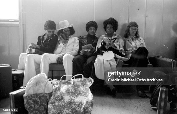 Singer Sly Stone of the psychedelic soul group "Sly & The Family Stone" awaits transportation with his actual family including his parents on August...