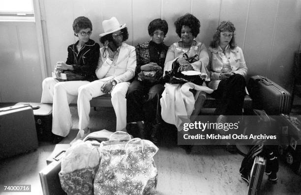 Singer Sly Stone of the psychedelic soul group "Sly & The Family Stone" awaits transportation with his actual family including his parents on August...