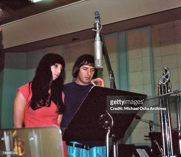 Entertainers Sonny Bono and Cher record in the studio at a Neumann mic in April 1966 in Los Angeles, California.