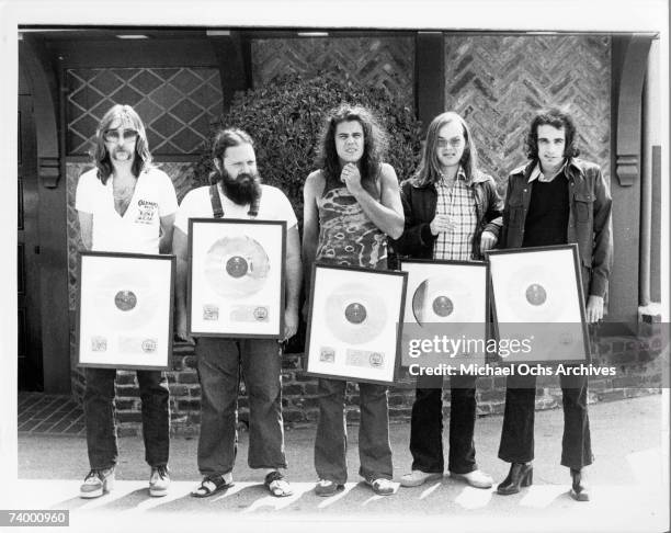 Jeff "Skunk" Baxter, Denny Dias, Jim Hodder, Walter Becker and Donald Fagen of the rock and roll band "Steely Dan" pose for a portrait at the gold...