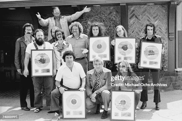 Front Row L-R: Joel Cohn, Manager; Marv Helfer, Manager, Jeff Skunk Baxter, Second Row L-R: Howard Rose, booking agent; Denny Dias; Bob Gibson,...