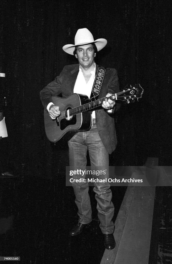 George Strait Rodeo Portrait Country musician George Strait poses for a portrait holding a Guild ...