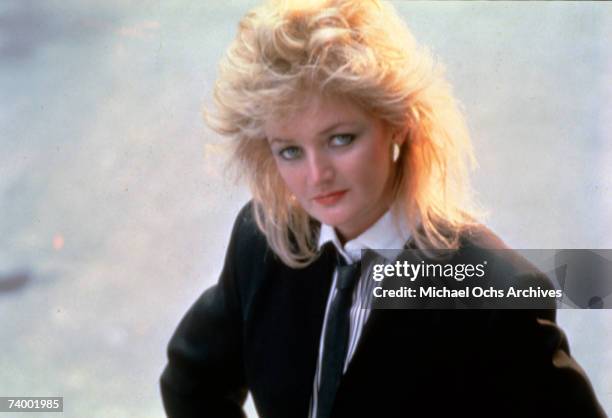 Welsh singer Bonnie Tyler wearing a suit jacket and tie, circa 1985.