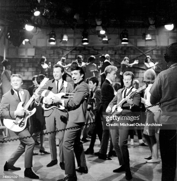 Don Wilson, Mel Taylor, Nokie Edwards and Bob Bogle of the rock and roll band "The Ventures" perform onstage on the TV show American Bandstand with...